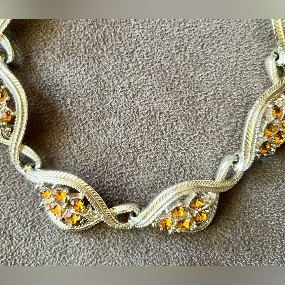 Vintage 16” necklace with marigold rhinestones. Gold tone metal.